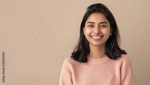 smiling young woman in pink color sweater