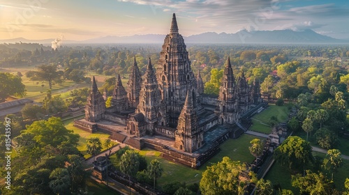 Aerial view of the Prambanan Temple in Indonesia, showcasing the Hindu temple complex with its towering spires surrounded by lush green landscape.      photo