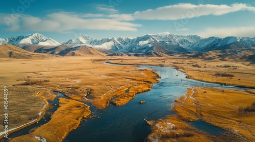 Aerial view of the Altai Mountains in Mongolia  featuring the snow-capped peaks  expansive steppes  and remote nomadic camps.     