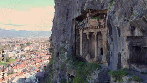 Huge Amyntas Tomb in Fethiye, Aerial Drone View, Muğla Türkiye: Built in the Year 350 BC. Ancient Old Rock-Cut Grave Site and Historical Landmarks. Scenic Peaceful Resting Place. With View Of Fethiye photo