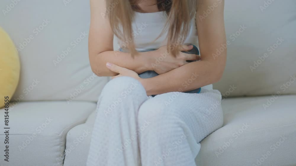 Menstruation period cycle of monthly and Stomachache concepts. woman having abdomen pain and menstrual ache with hot water bottle, illness female suffer from premenstrual ache and body Health problem Menstruation period cycle of monthly and Stomachache concepts. woman having abdomen pain and menstrual ache with hot water bottle, illness female suffer from premenstrual ache and body Health problem