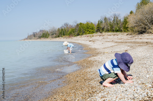 Young Children playing with buckets on a Lake Huron beach