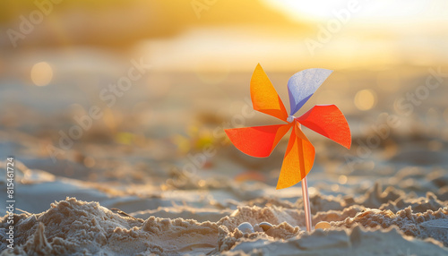 Paper pinwheel in a sand on the beach, summer concept, copy space