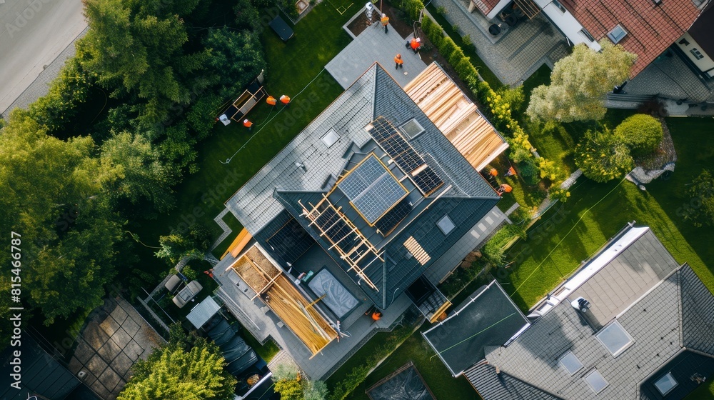 Aerial perspective of roofers on a house, focusing on the application of roofing materials and the structure of the property Aerial perspective of roofers on a house, focusing on the application of roofing materials and the structure of the property