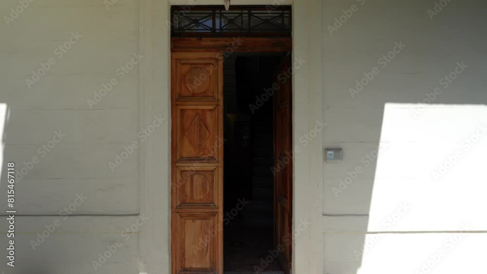 Slow dolly shot towards a half-open wooden door to a villa in Montpellier Slow dolly shot towards a half-open wooden door to a villa in Montpellier
