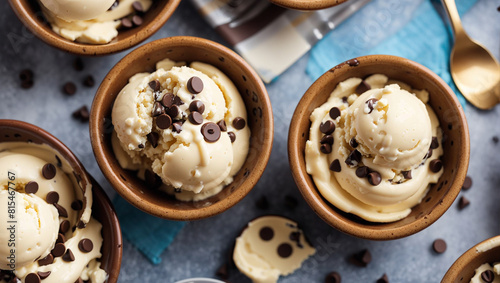 There are four bowls made of chocolate chip cookies, each filled with vanilla ice cream and chocolate chips.

 photo