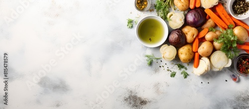 This is a top view image featuring a healthy artichoke dinner made with olive oil potatoes carrots and onions on a gray floor background The copy space image allows text to be added photo