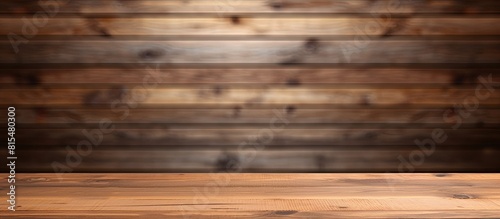 A contemporary wooden table is seen against a blurred wood plank wall with a template mock up for displaying or editing product images. Creative banner. Copyspace image