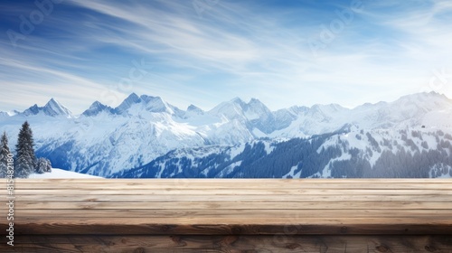 Wooden table top with snow mountains and trees in background