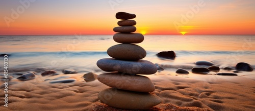 On the Praia da Luz beach at sunset a serene and meditative atmosphere is created by carefully stacked stones It s a harmonious and balanced display of art that adds tranquility to the otherwise empt