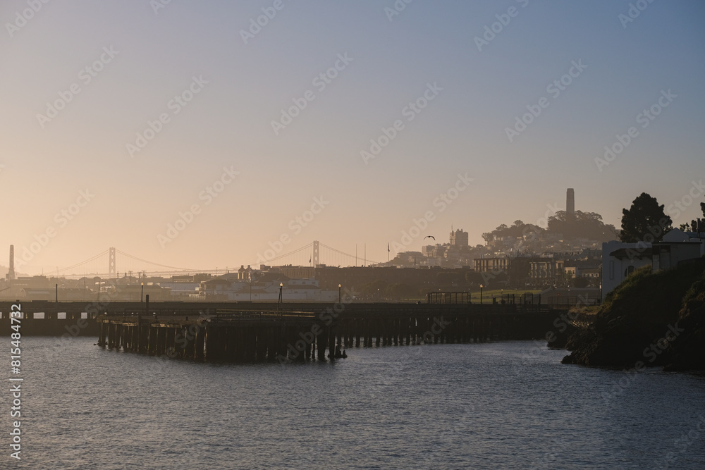 Morning sunrise dawn above San Francisco Bay with panoramic scenic views of coast, Alcatraz, skyline silhouette and port marina harbor with marine traffic and birds Morning sunrise dawn above San Francisco Bay with panoramic scenic views of coast, Alcatraz, skyline silhouette and port marina harbor with marine traffic and birds