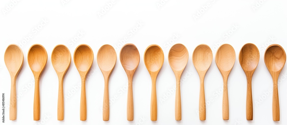 A simple and clean image showcasing wooden spoons on a white background with plenty of copy space A simple and clean image showcasing wooden spoons on a white background with plenty of copy space