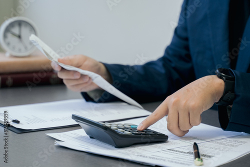 Busines using a computer to omplete income tax return form online. Income Statement. photo