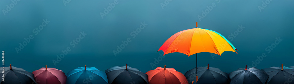A surreal scene features a rainbow umbrella standing out from an array of black umbrellas, set against a minimalist color backdrop. The vivid colors of the umbrella highlight themes of individuality