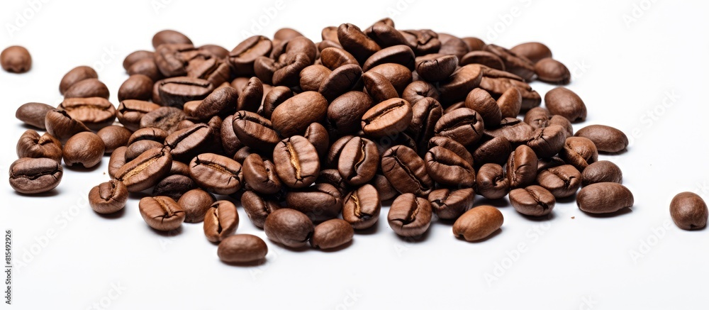 Obraz premium A high quality macro image of roasted brown and black coffee beans is isolated on a white background providing ample copy space for text