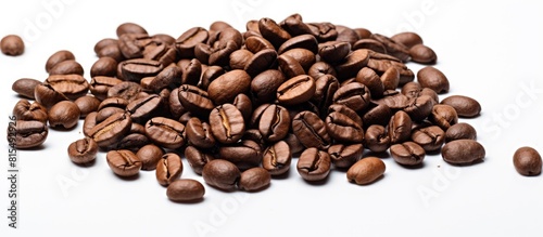 A high quality macro image of roasted brown and black coffee beans is isolated on a white background providing ample copy space for text