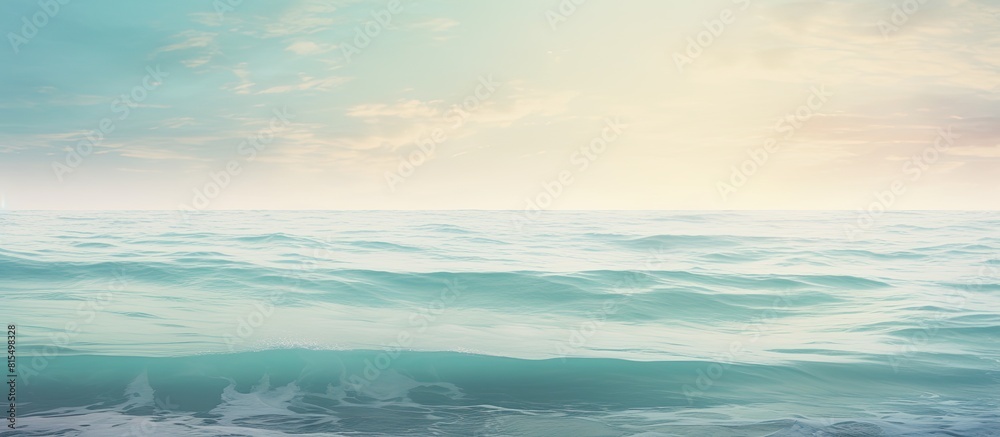 Naklejka premium A calming scene of the ocean s serene surface with the soft morning light creating a textured effect Copy space image