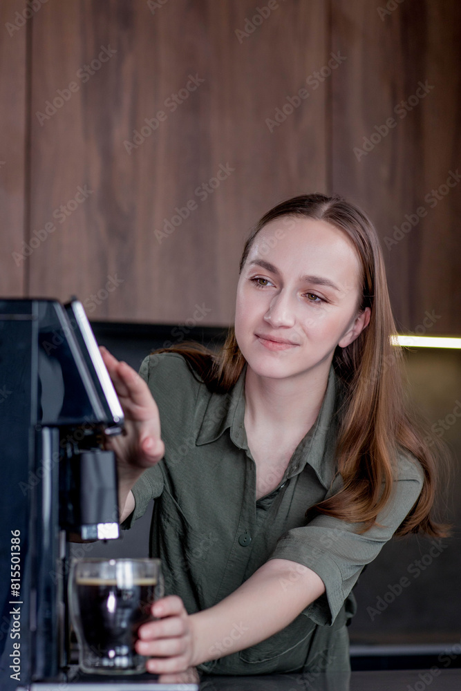 Woman preparing a fresh coffee with a coffee maker machine. Coffee blender and household kitchen appliances for makes hot drinks Woman preparing a fresh coffee with a coffee maker machine. Coffee blender and household kitchen appliances for makes hot drinks