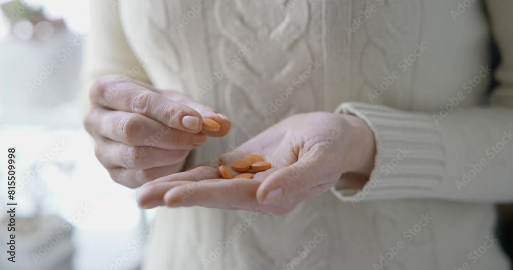 pharmacy and treatment concept - close up view of Caucasian woman holding Vitamin C tablets in her palm
