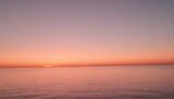 A sunset over the ocean with gradients of apricot upscaled_10