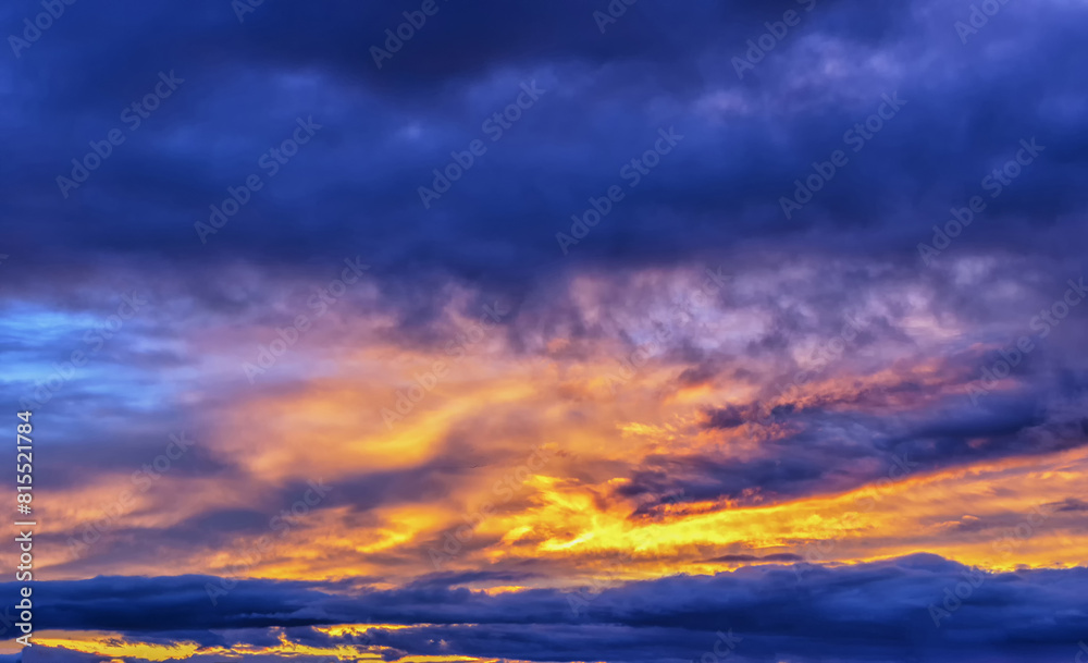 Orange fiery evening sunset sky with clouds