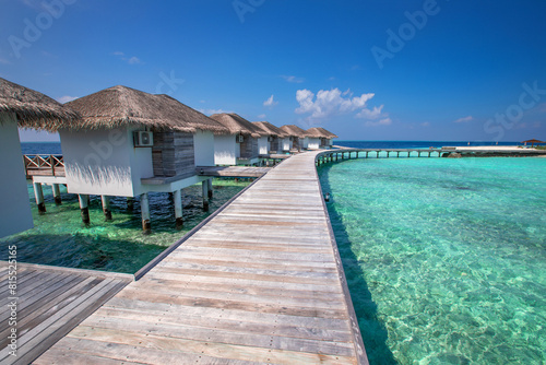 hotel water villas in Maldives  beach vacations  wooden pier and houses on pillars with straw roofs