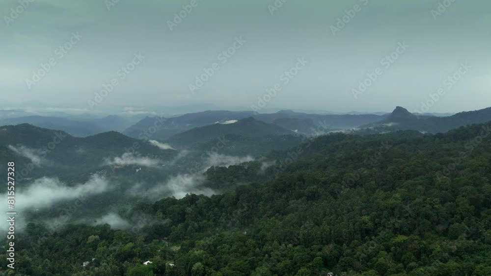 Distant aerial view of a dense rainforest vegetation mountains and misty clouds areal views of munnar kerala india