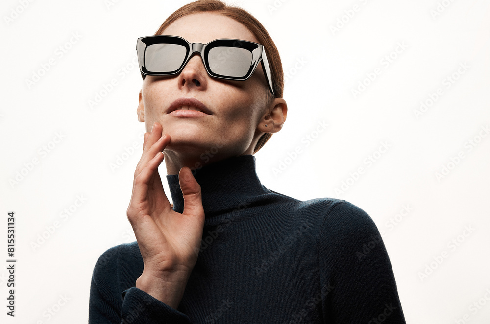 Studio portrait of a sexy girl in glasses with smoothed hair. Grain effect used Studio portrait of a sexy girl in glasses with smoothed hair. Grain effect used