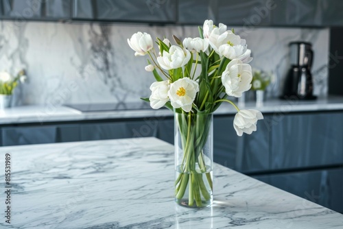 A marble kitchen countertop with spring flowers in a vase on the table