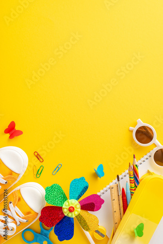 Vibrant vertical image featuring playful summer educational tools including sneakers, sunglasses, notebooks, and a decorative pinwheel placed on a bright yellow background © ActionGP