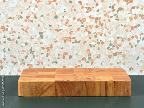 A sturdy wooden pedestal, perfect for product placement, set against a stylish mosaic background