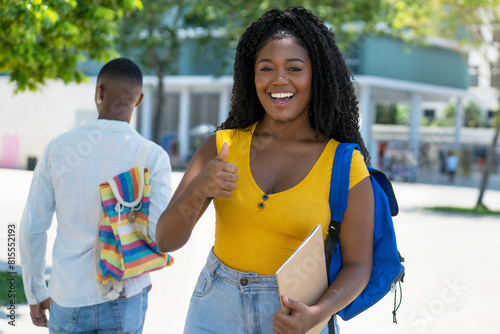 Successful black female student showing thumb up