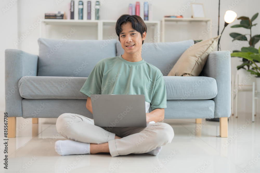 Young man working on laptop at home Young man working on laptop at home