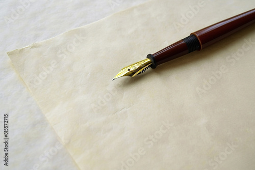 Vintage fountain pen on aged paper in a warm lit setting