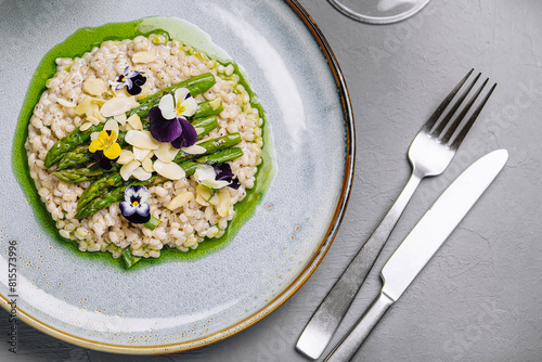 Gourmet risotto with edible flowers on elegant table setting