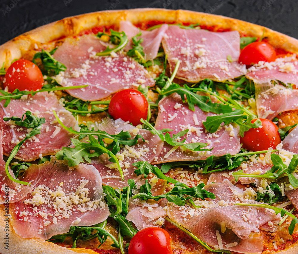 Gourmet italian pizza with prosciutto and arugula