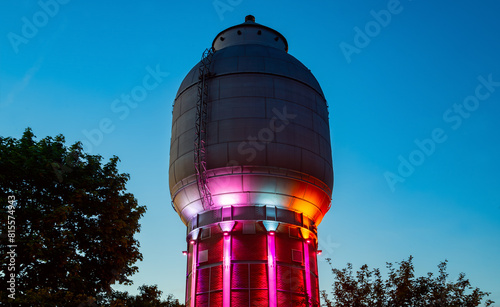Historic water tower in Neunkirchen (Saarland, Germany), part of ancient steel mill and blast furnace called “Altes Hüttenareal“. Public sight and tourist attraction at evening twilight at blue hour.