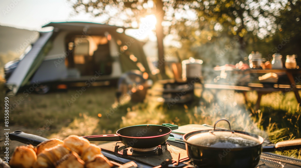 A sunny outdoor campsite with a focus on a cooking setup. A sunny outdoor campsite with a focus on a cooking setup.