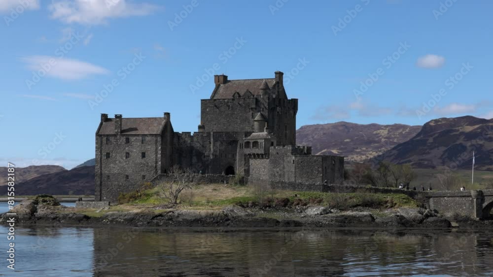 Hand-held shot of tourists exploring the exterior of Eilean Donan Castle Hand-held shot of tourists exploring the exterior of Eilean Donan Castle