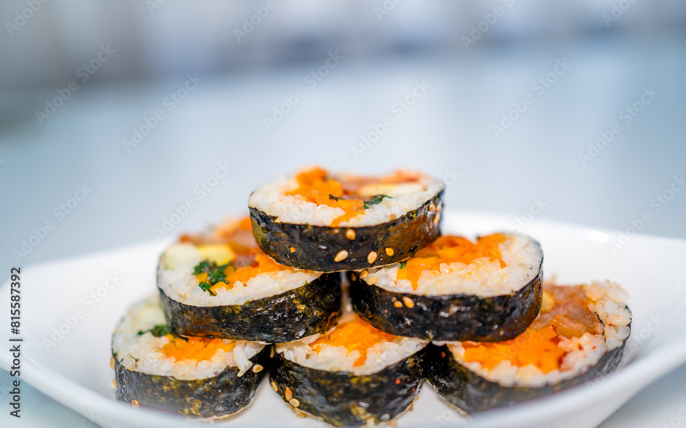 closeup view of kimbap rolling rice on white plate. closeup view of kimbap rolling rice on white plate.