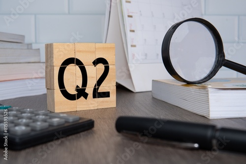 Close up image of wooden cubes with alphabet Q2 on office desk. Second quarter concept.