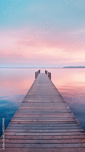 A serene wooden pier extending into a tranquil lake  under a pastel sunset sky  creating a tranquil atmosphere.copy space