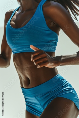Dynamic Close-Up of a Fit African American Woman in Blue Athletic Wear, Emphasizing Strength and Healthy Lifestyle