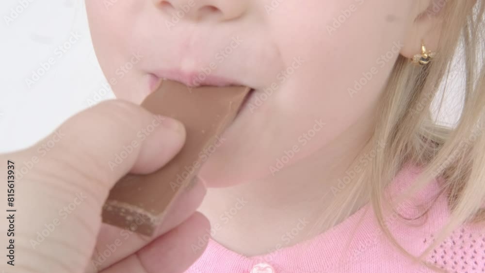 happy little girl 4 years old enjoys delicious chocolate bar, child eating sugary snack, delicious sweetness, Childhood memories, Simple joys, sweet treat, little moments of joy