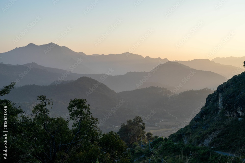 Mountain range illuminated by the warm light of the setting sun. Mountain range illuminated by the warm light of the setting sun.