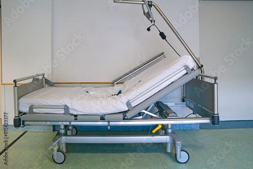 Medicine Ideas. Hospital Bed with no Patient in the Hospital Ward Room and Stand with Blanket and Pillow photo