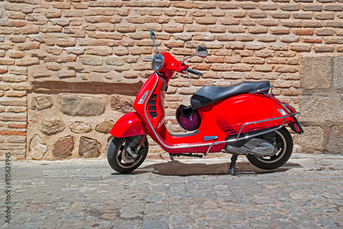 Red Vintage Scooter Parked on Street of Spain as one of The Most Popular Transport in Toledo