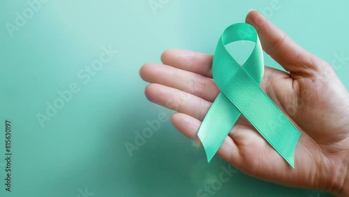 Woman holding Teal Ribbon for Cervical Cancer Awareness month, Healthcare, world cancer day, world ovarian cancer day, Uterus and Ovaries