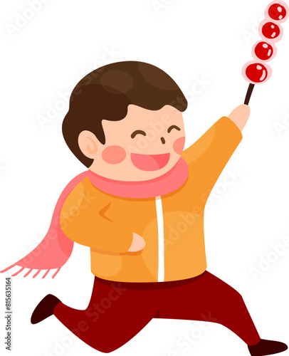 Boy holding a sugar coated fruit stick walking happily