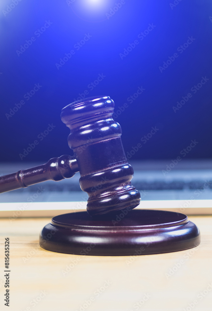 Judge Hammer for adjudication with wooden stand and laptop on it. Auction or Lawyer decision. Law and justice concept. Court of law. Pronouncing sentence, striking Gavel. Judge Hammer for adjudication with wooden stand and laptop on it. Auction or Lawyer decision. Law and justice concept. Court of law. Pronouncing sentence, striking Gavel.